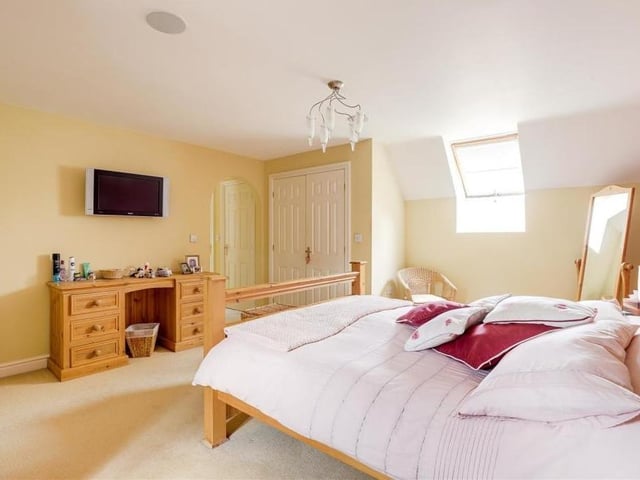 The master bedroom sits proudly at the top of the Longdale Lane property on the second floor, with a window facing the front. It includes an in-built wardrobe and a carpeted floor.