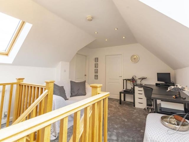 We're moving upstairs now, to be greeted by this functional landing that could easily be turned into a mini-office. It has a carpeted floor, downlights and a Velux window.