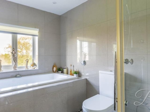 There are bathrooms on the first and second floors of the £750,000 house. Here is the former, which features a bath, enclosed shower, low-flush WC and wash hand basin.