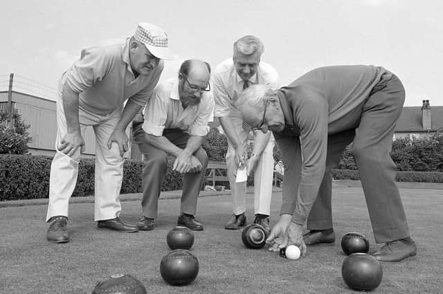 A group of Kirkby bowlers measure a shot back in 1970.