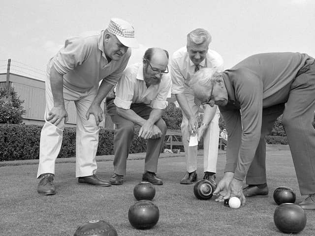 A group of Kirkby bowlers measure a shot back in 1970.