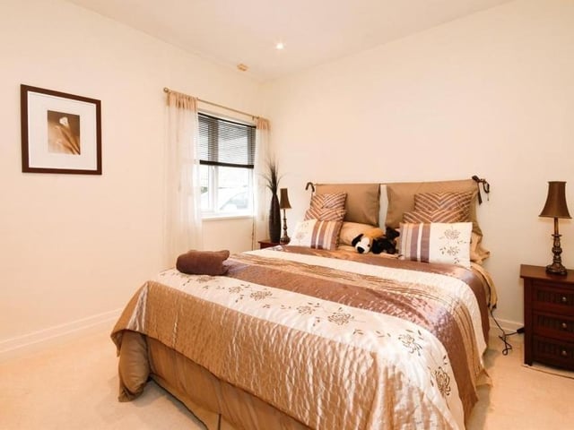 The fourth and final bedroom is a cosy, comfortable space, with a window facing the side of the property and recessed spotlights.