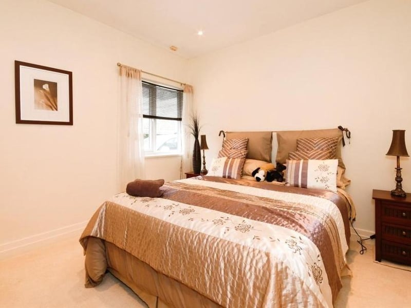 The fourth and final bedroom is a cosy, comfortable space, with a window facing the side of the property and recessed spotlights.