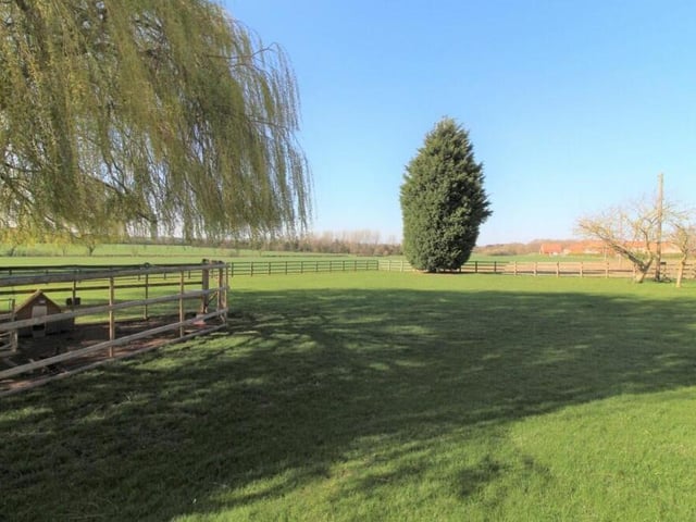 The house sits on beautiful grounds that span almost an acre and include an extensive lawned garden.