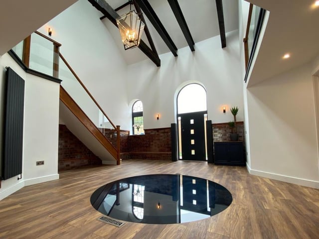 The ground floor of the property is divided into two habitable zones either side of the atrium. Private living spaces are located to the north, and more public zones, such as the dining kitchen, living room and sun rooms, to the south. The centrepiece of the atrium is the glass plate that allows you to see down the Victorian well, which extends 17 metres below the ground.