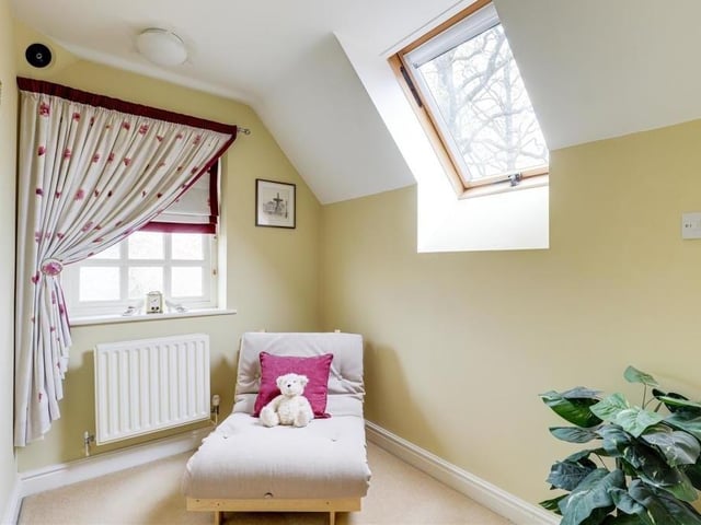 A loft space on the third floor could be converted into a walk-in wardrobe. It has a carpeted floor and a radiator.