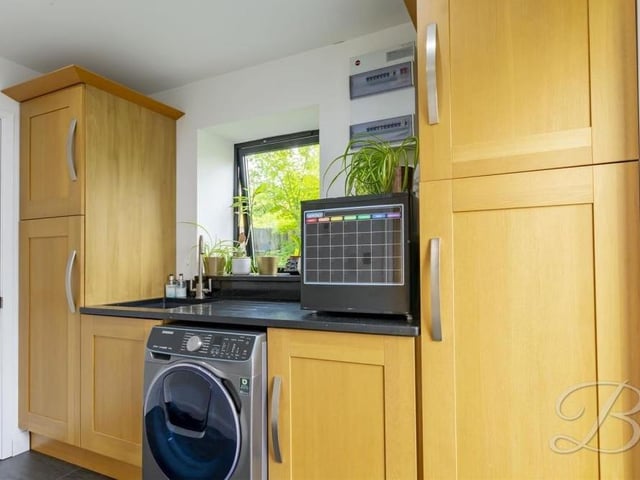This utility room is a handy addition to the ground floor, especially with its shaker-style cabinets and units, work surface and inset sink with mixer tap above. There is space and plumbing for a washing machine too.