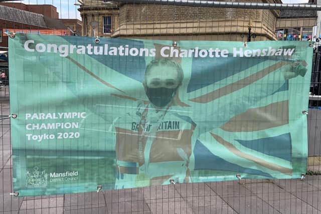 A banner celebrating Charlotte Henshaw's success attached to fencing around Mansfield's Bentinck Memorial in the centre of Market Place.