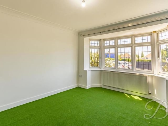 Strip away the golf equipment and this is what one of the reception rooms looks like at the front of the house. Both have a TV point and underfloor heating.