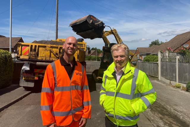 Highways worker Lee Wright (let) and Coun Neil Clarke at a road repair in the county