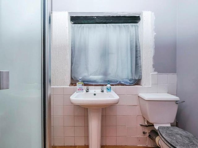 The annexe has double opening doors and, inside at present, it comprises a shower room, with shower cubicle, low-level WC, pedestal wash hand basin and a window.