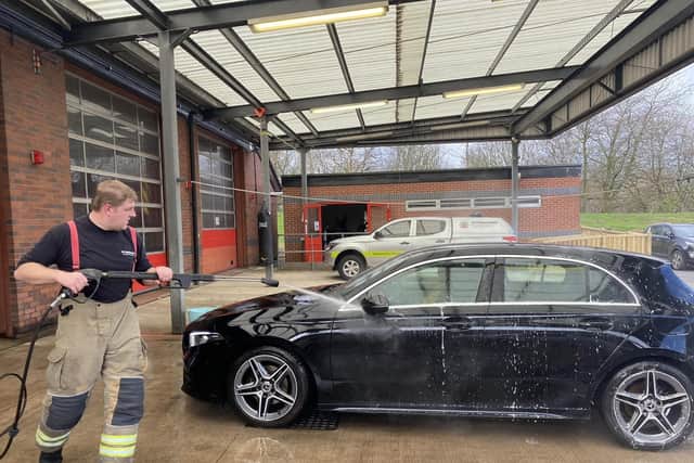 Firefighters hard at work at a previous charity car wash at Ashfield Fire Station