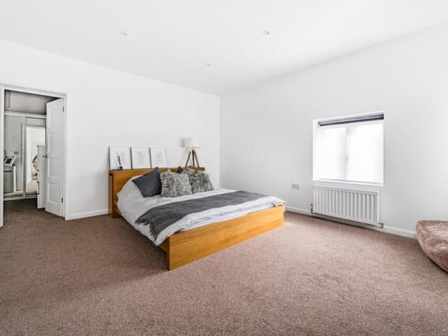 As we move up to the first floor, here is the main bedroom, which occupies a vast space. It provides a touch of luxury, with lots of room for storage and furniture.