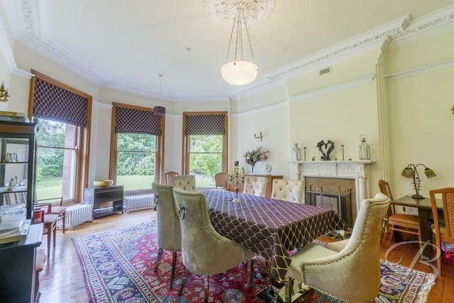 The dining room at the £875,000 mansion is a lovely spot for family meals and for entertaining friends. Assets include wooden-plank flooring, a feature fireplace and three superb bay windows facing the side of the property.