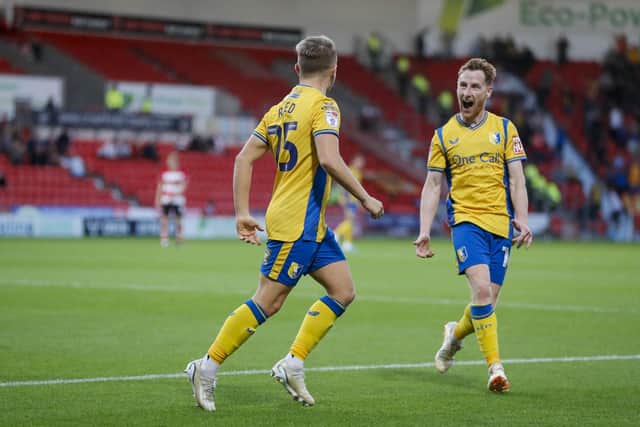 Mansfield Town's Louis Reed celebrates his goal with Stephen Quinn during the Sky Bet League 2 match against Doncaster Rovers FC at the Eco-Power Stadium  
Photo Chris & Jeanette Holloway / The Bigger Picture.media