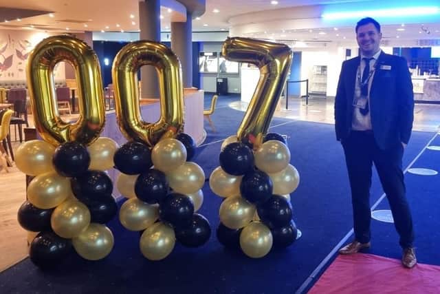 Manager Nathan Hannah puts out the 007 balloons to celebrate the opening night of 'No Time To Die' at Mansfield's Odeon Cinema complex.