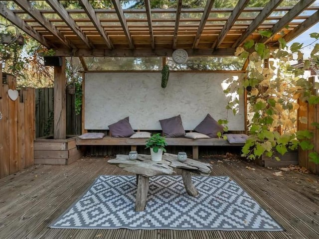 The garden offers so much, including this raised, decked seating area, beneath a pleasant pergola, that offers an elevated view.