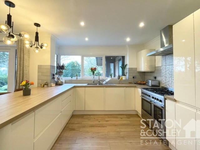 A closer look at the kitchen, which includes an integrated fridge/freezer, dishwasher, range cooker and five-ring gas hob. There is also a breakfast bar, tiled splashbacks, laminate flooring and spotlights.