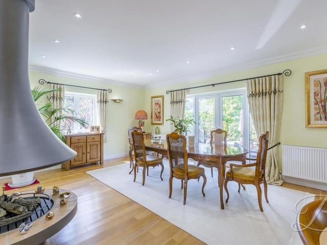 Beyond the central fireplace is this lovely dining area. The French doors lead out to the spacious back garden.