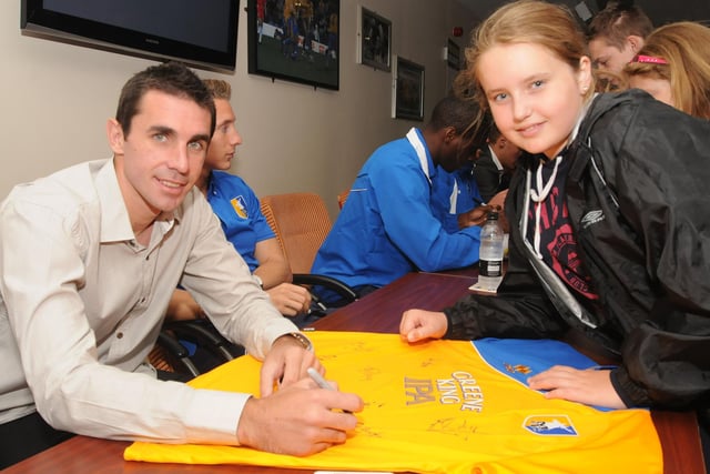 New signing John Thompson signs a shirt at Stags open day along with Amber Melling