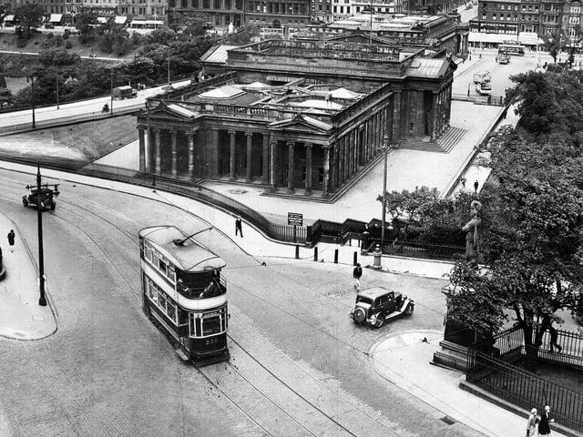 A tram makes its way up the Mound, with snow lying on the ground, in 1955.