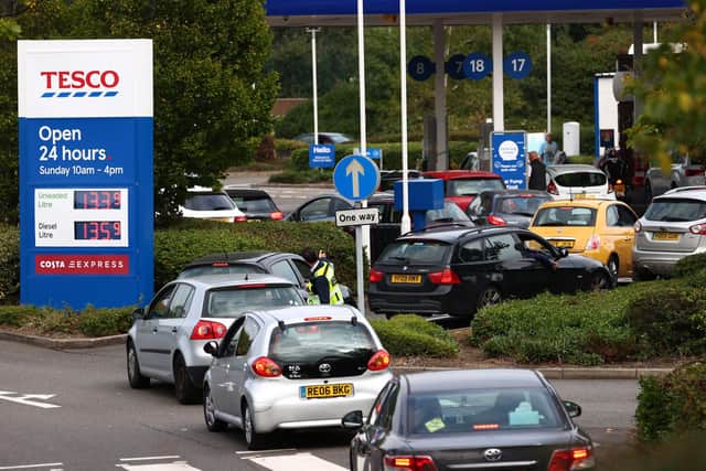 Queues snake round the road leading to this Tesco service station. (PHOTO BY: Adrian Dennis/Getty Images)