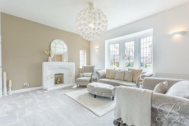 The first room to catch the eye on the ground floor of the West Hill Avenue house is this brilliant living room. It is distinguished by a large bay window facing the front of the property, and a feature fireplace.