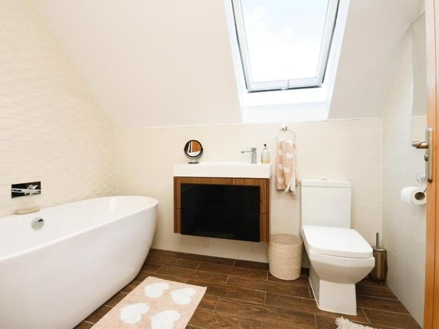 All three double bedrooms at the Main Road house benefit from en suite bathrooms. This stylish one belongs to the master on the top floor of the property.