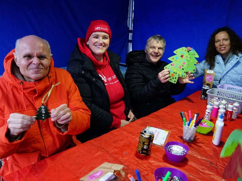 Stacey Lerase from Art Venturers helping residents from Corner House make decorations.