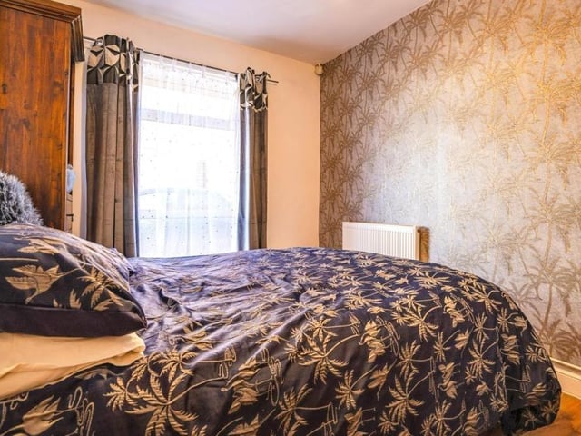 There are three other double bedrooms, including this stylish one with laminate flooring.