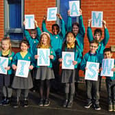 Pupils at Kirkby's Kingsway Primary School celebrate their good Ofsted report.