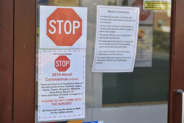 A picture shows signage at the front of the Avenue Surgery health centre in Brighton, southern England on February 12, 2020, which is offering a very limited service after a doctor at the surgery came into contact with a patient that tested positive for coronavirus COVID-19 and chose to self-isolate. (Photo by Glyn KIRK / AFP)