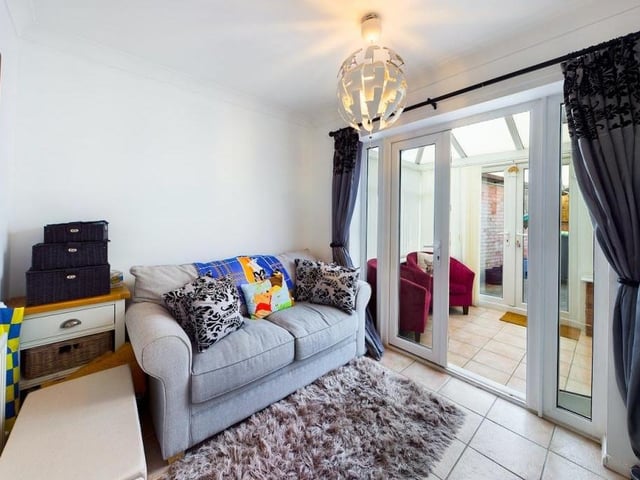 The second bedroom, currently being used as a reception room, has doors that give access to the conservatory at the Nuncargate Road bungalow.