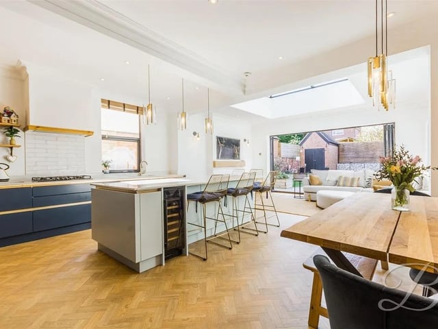 The living and dining area provides ample room for your desired furnishings, complemented by a cosy fireplace, a skylight, and bi-folding doors leading to the rear garden.