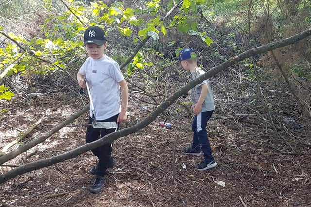 Two youngsters hard at work picking litter, as part of the Just Bin It initiative, at Racecourse Park in Mansfield.