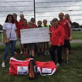 Members of Sutton Harriers, with their new equipment, receive the cheque from Mandy Whitten, products coordinator at Mansfield Building Society