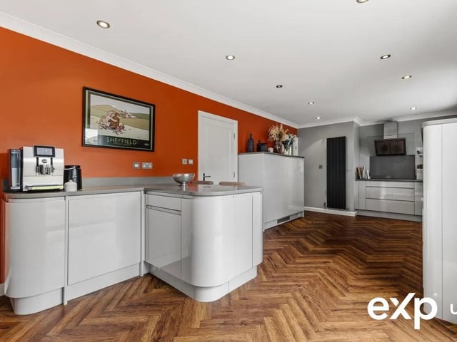 A breakfast bar peninsula adds informal kitchen dining and top-quality appliances include a fridge, freezer, dishwasher, oven, combination microwave oven, warming drawer and induction hob with extractor above.