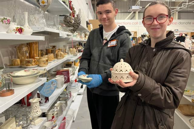 Samuel Pashley-Smith (left) and Shania Walker rotate stock in the household goods area.
