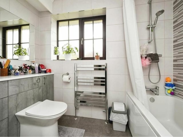 The en suite bathroom to the primary bedroom is superbly stylish. Admire a bath with shower over, hand wash basin, WC, towel-rail and lots of storage space.