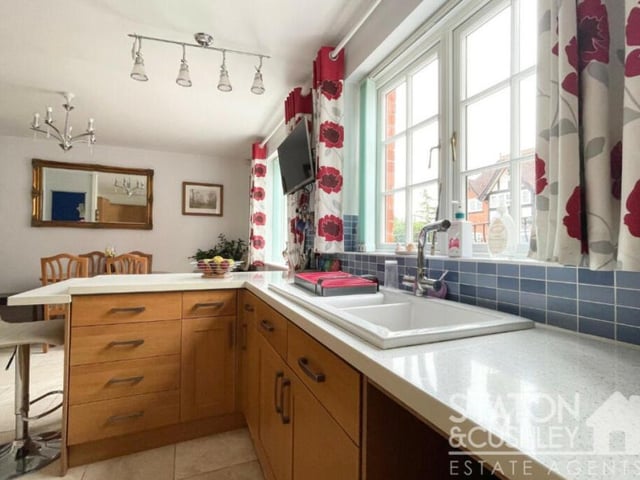 The kitchen/diner is fitted with oak wall and base units with drawers and square-edge worktops, plus a one-and-a-half-bowl sink and drainer with mixer tap.