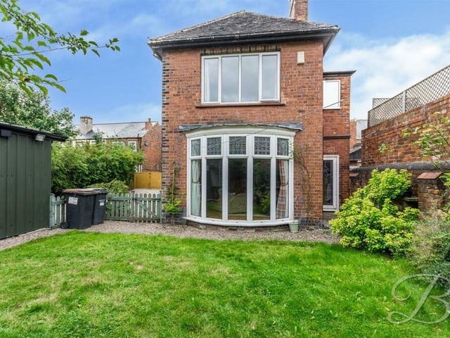 Time to step outside now, and here is a view of the rear of the property, with the large bay window of the living room overseeing the lawn of the garden.