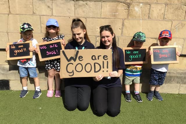 Staff members Ashleigh Halfpenny and Abbie Dahill celebrate the good Ofsted rating with some of the youngsters.