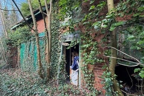 Behind the property, the garages are in a state of disrepair. However, the potential for the property and its space is limitless.