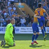 Mansfield's players celebrate Mal Benning's most famous goal for the club as he shoots down Chesterfield away from home in April 2019.