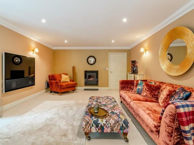 Next stop is the spacious lounge,which includes a modern wall-mounted fireplace with inset gas fire and granite hearth beneath. A comfortable, relaxing space, it has six ceiling spotlights and three wall-light points.