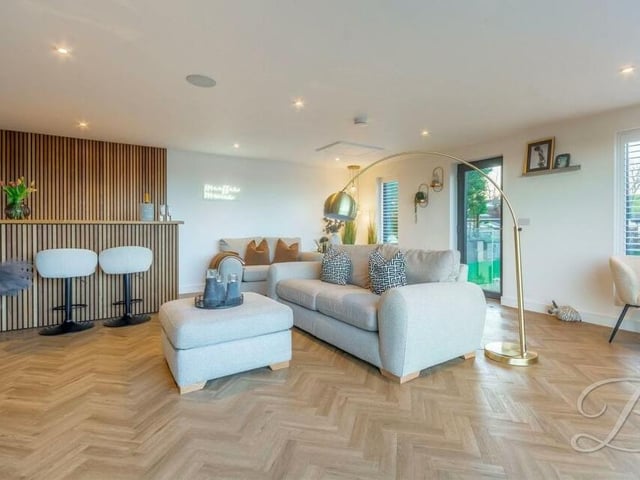 The garage extension actually has planning permission for a separate dwelling, But the current owners are using it as an extra social space, with LVT (luxury vinyl tile) parquet flooring and built-in wine cooler.