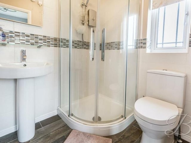 Here is the en suite shower room that is attached to the master bedroom. It comprises a shower cubicle, hand wash basin and low-flush WC.