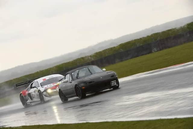 Karen in her Mazda MX-5 takes on an R8 racecar in the wet at Snetterton Circuit in Norfolk.