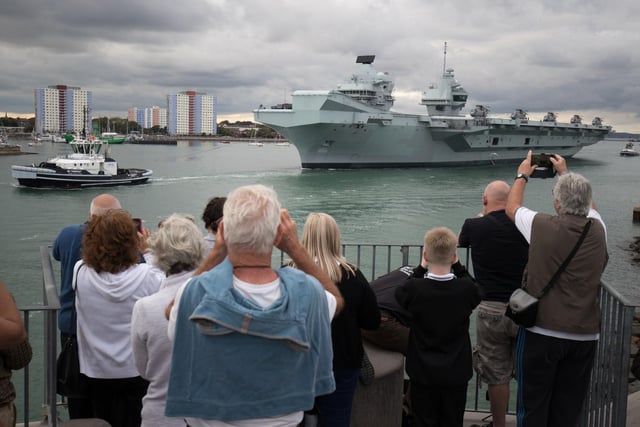 People wave from the Round Tower in Old Portsmouth as HMS Queen Elizabeth departs. Picture: Andrew Matthews/PA Wire