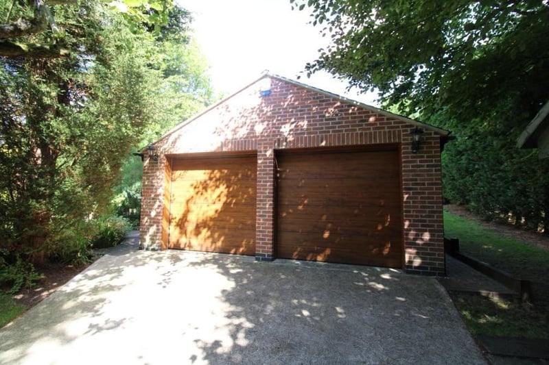 One of the driveways leads to this detached double garage, with two electric roll-up doors, light and power. Other outbuildings in the grounds include a brick-built potting shed, brick-built coal house, log store and greenhouse.